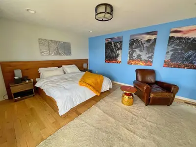 a bedroom with a bed and a chair at Modern Luxury Home I Sleeps 8 I 10min to Downtown in Denver