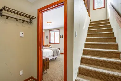 a staircase leading to a bedroom with a bed at Downtown Frisco Townhome about 1 Mi to Lake Dillon! in Frisco