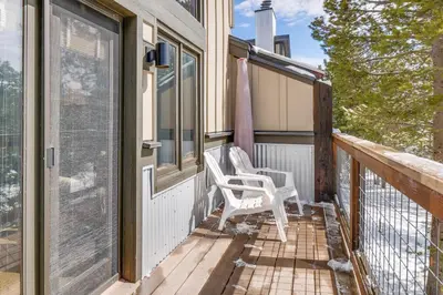a porch with two white chairs on it at Downtown Frisco Townhome about 1 Mi to Lake Dillon! in Frisco