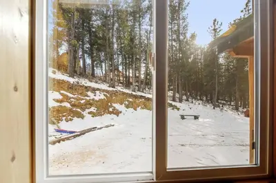 a window with a view of a snow covered field at Skipper's Cabin in Pine
