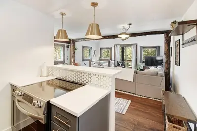 an open kitchen and living room with a couch at Skipper's Cabin in Pine