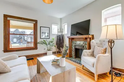 a living room with a couch and a fireplace at 4 Mi to Downtown Denver Washington Park Hideaway! in Denver