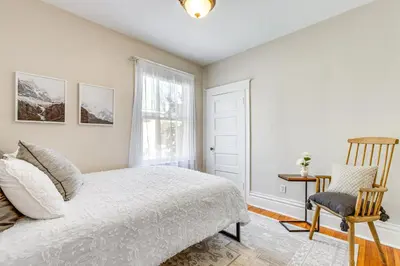 a bedroom with a bed and a chair at 4 Mi to Downtown Denver Washington Park Hideaway! in Denver