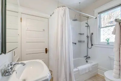 a white bathroom with a sink and a shower at 4 Mi to Downtown Denver Washington Park Hideaway! in Denver