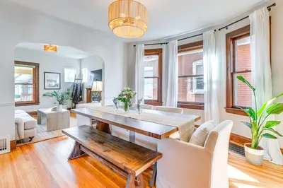 a living room with a wooden table and chairs at 4 Mi to Downtown Denver Washington Park Hideaway! in Denver