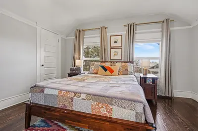 a bedroom with a bed and a large window at 5-Bedroom Victorian Home Private Yard Sleeps 10 in Denver