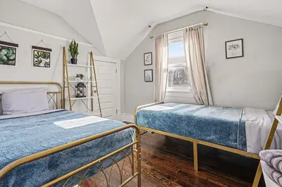 a bedroom with two beds and a window at 5-Bedroom Victorian Home Private Yard Sleeps 10 in Denver