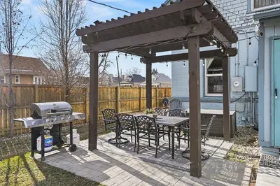 a patio with a grill and a table and chairs at 5-Bedroom Victorian Home Private Yard Sleeps 10 in Denver