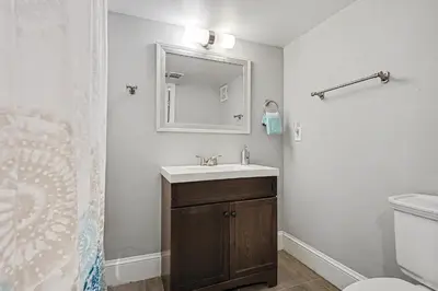a bathroom with a sink and a mirror at 5-Bedroom Victorian Home Private Yard Sleeps 10 in Denver