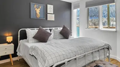 a bedroom with a white bed with pillows at Lakeside 1BR 4-Min to Keystone Ski Resort in Keystone