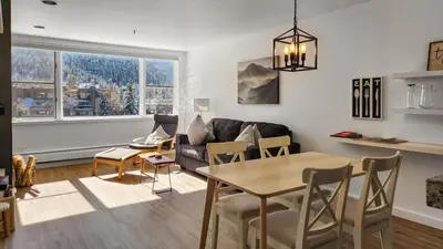 a living room with a table and a couch at Lakeside 1BR 4-Min to Keystone Ski Resort in Keystone