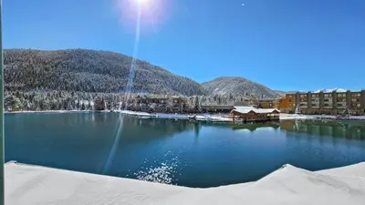 a large body of water with buildings and mountains at Lakeside 1BR 4-Min to Keystone Ski Resort in Keystone