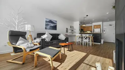 a living room with a couch and chairs and a kitchen at Lakeside 1BR 4-Min to Keystone Ski Resort in Keystone