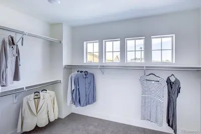 a walk in closet with clothes on racks at Stunning Golf Course View in Denver in Denver