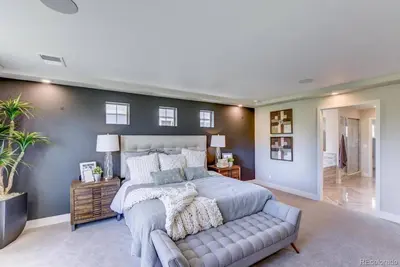 a bedroom with a large bed and a couch at Stunning Golf Course View in Denver in Denver