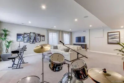 a living room with drums and a couch at Stunning Golf Course View in Denver in Denver