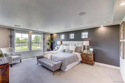 a bedroom with a large bed and a chair at Stunning Golf Course View in Denver in Denver
