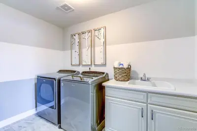 a kitchen with a washing machine and a sink at Stunning Golf Course View in Denver in Denver