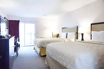a hotel room with two beds and a window at Argo Inn and Suites in Idaho Springs