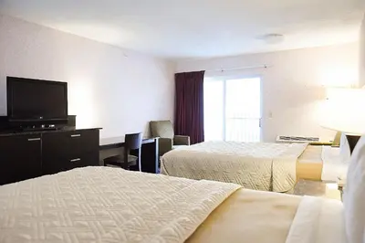a hotel room with two beds and a flat screen tv at Argo Inn and Suites in Idaho Springs
