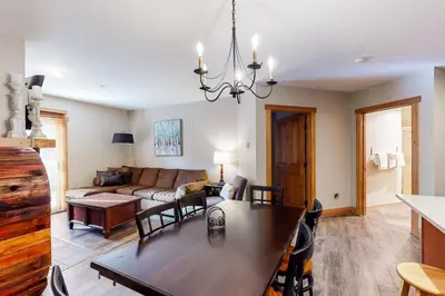 a living room with a table and a couch at Red Hawk Lodge 2 Bedroom Condo In River Run Village in Keystone