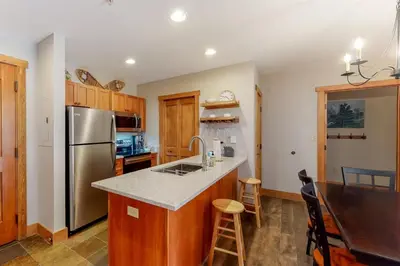 a kitchen with a stainless steel refrigerator freezer at Red Hawk Lodge 2 Bedroom Condo In River Run Village in Keystone