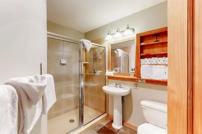 a bathroom with a shower and a toilet and a sink at Red Hawk Lodge 2 Bedroom Condo In River Run Village in Keystone