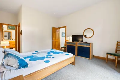 a bedroom with a bed and a desk and a mirror at WaterDance #475A in Frisco