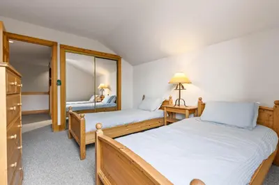 a bedroom with two beds and a mirror at WaterDance #475A in Frisco