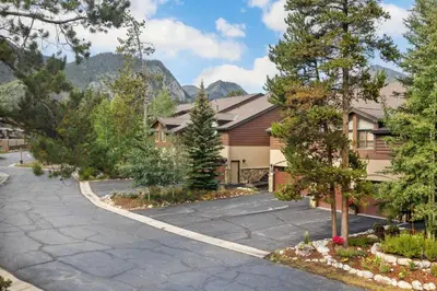 a driveway in front of a building with trees at WaterDance #475A in Frisco