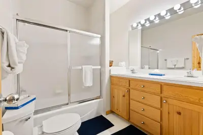 a bathroom with a shower and a toilet and a sink at WaterDance #475A in Frisco