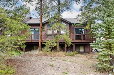 a large house with a deck in the woods at WaterDance #475A in Frisco