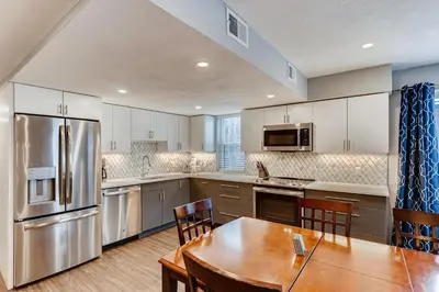 a large kitchen with a wooden table and a dining room at Mountainside #272H in Frisco
