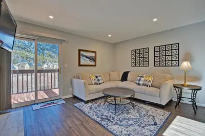 a living room with a couch and a table at Mountainside #272H in Frisco