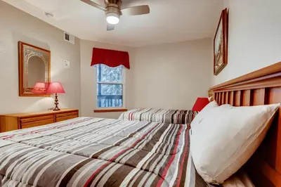 a bedroom with a large bed and a window at Mountainside #272H in Frisco