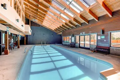 a large swimming pool in a building with a ceiling at Mountainside #272H in Frisco