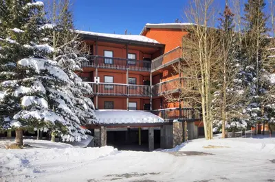 a large apartment building with snow on the ground at Mountainside #162H in Frisco