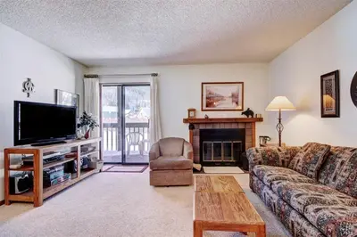 a living room with a couch and a television at Mountainside #162H in Frisco