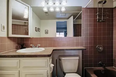 a bathroom with a sink and a toilet and a mirror at Mountainside #162H in Frisco