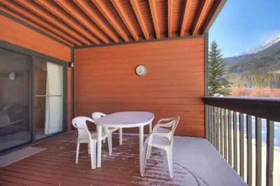a patio with a table and chairs on a deck at Mountainside #162H in Frisco