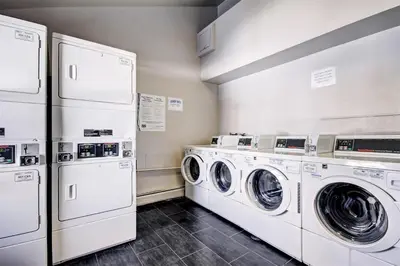 a laundry room with three washers and dryers at Mountainside #162H in Frisco