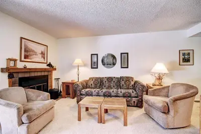a living room with a couch and two chairs at Mountainside #162H in Frisco