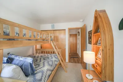 a bedroom with two bunk beds and a lamp at River Glen #106C in Frisco