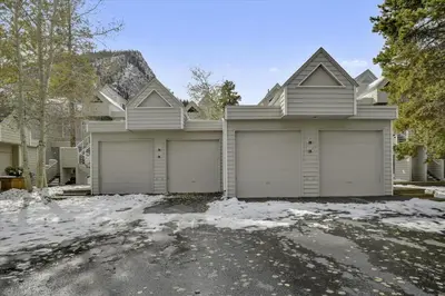 a house with four garage doors in the snow at River Glen #106C in Frisco