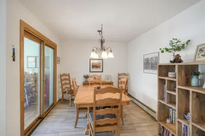 a dining room with a wooden table and chairs at River Glen #106C in Frisco
