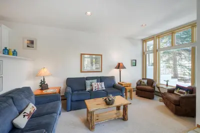 a living room with two blue couches and a table at River Glen #106C in Frisco