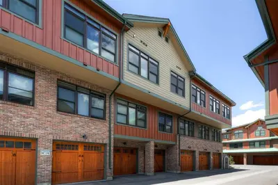 an apartment building with brown garage doors and red brick at Boulevard Bend P2 in Frisco