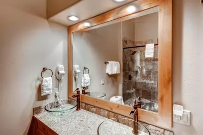 a bathroom with a sink and a large mirror at Boulevard Bend P2 in Frisco