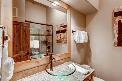 a bathroom with a sink and a shower with a mirror at Boulevard Bend P2 in Frisco