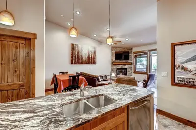 a kitchen with a sink and a living room at Boulevard Bend P2 in Frisco